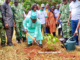Foli-Bazi Katari, ministre de l'environnement et des ressources forestières en train de mettre un plant en terre ce 1er juin 2023 dans le cadre du lancement de la campagne de reboisement national