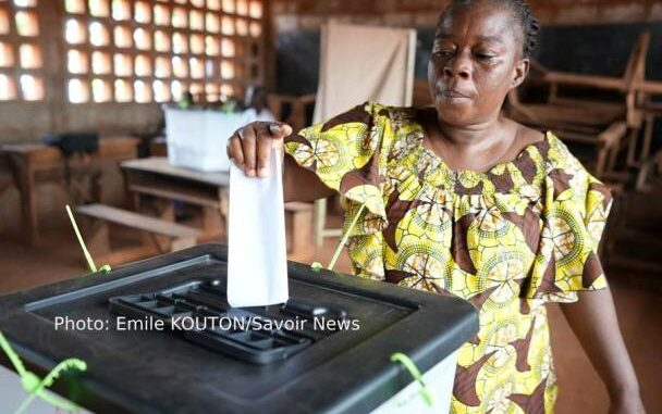 Une électrice glissant son bulletin dans l'urne le 17 juillet 2025 dans un bureau de vote à Lomé...